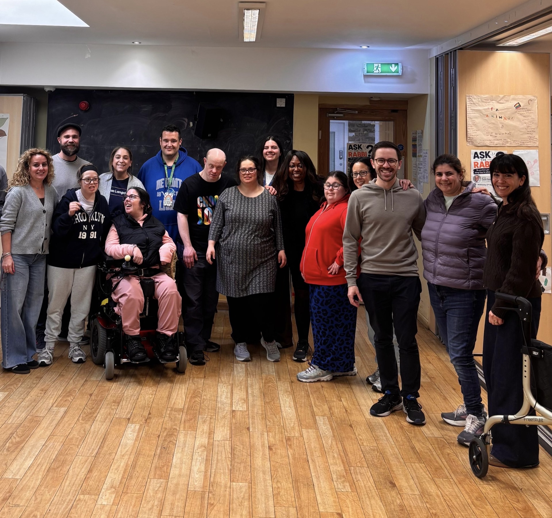 Volunteers supporting members at a community dance session